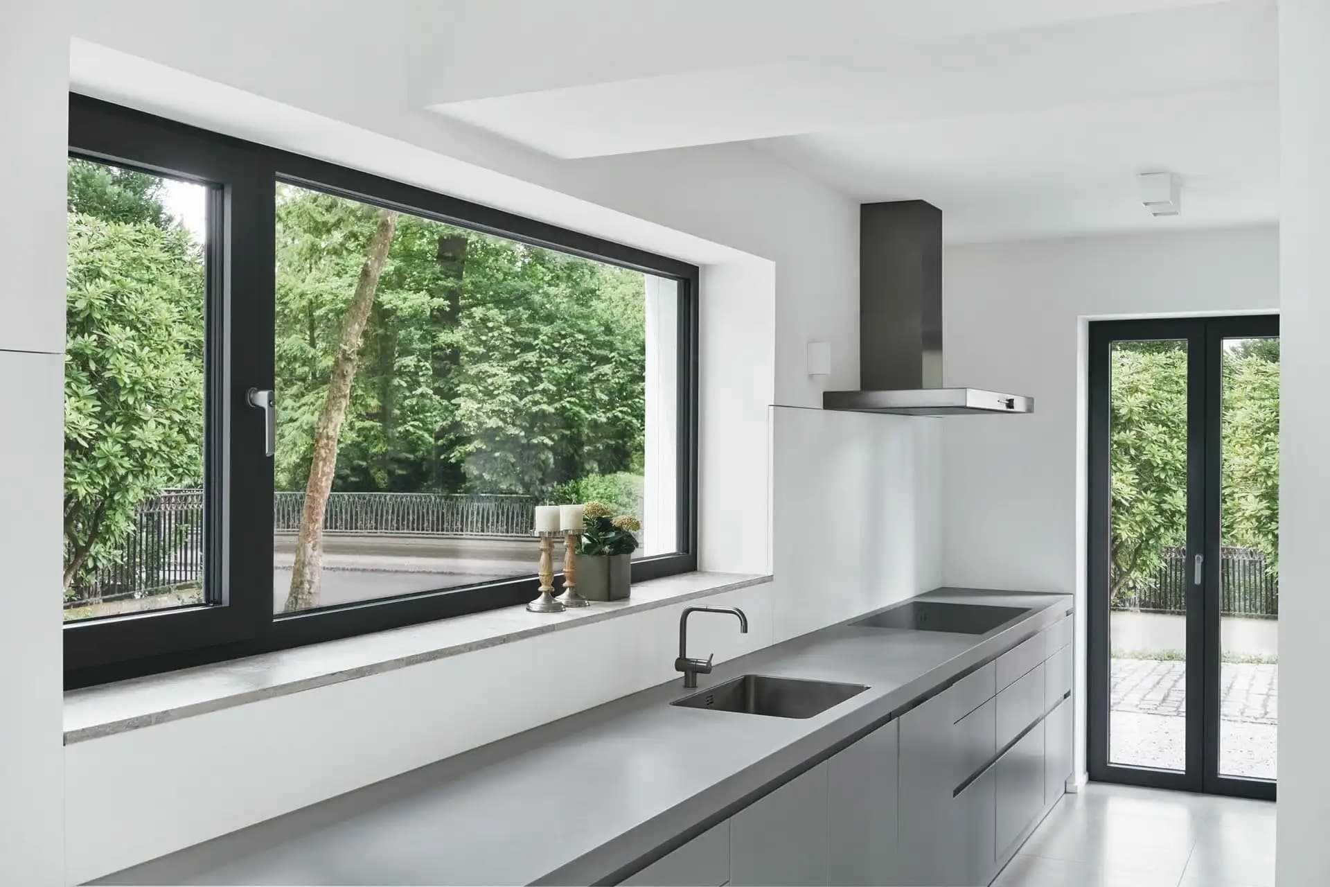 Grey powder-coated aluminium windows with multi-panel configuration providing excellent ventilation and enhanced security features