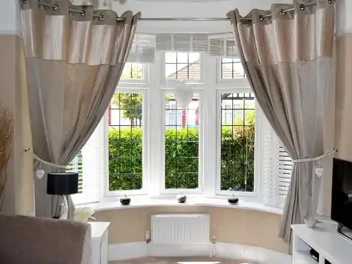 Bay window creating a cozy reading nook with built-in seating and storage