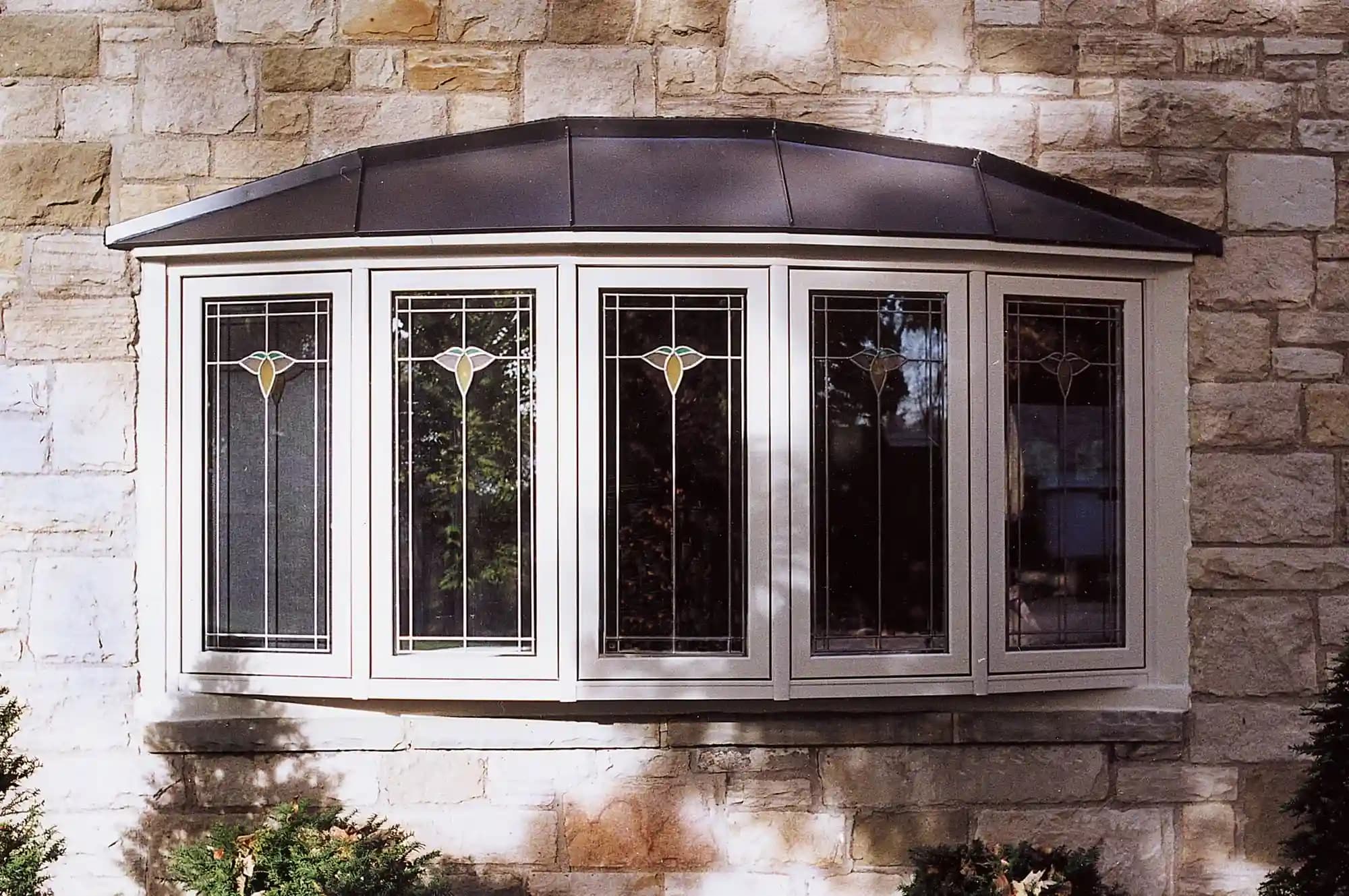 Large multi-panel bay window installation flooding interior with natural daylight