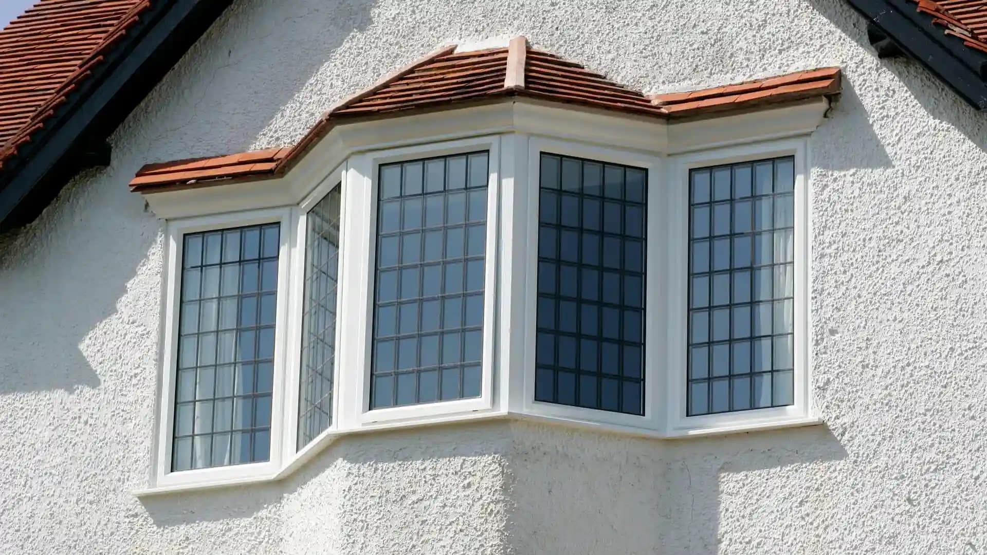 Traditional white bay window with decorative glass elements in a classic home